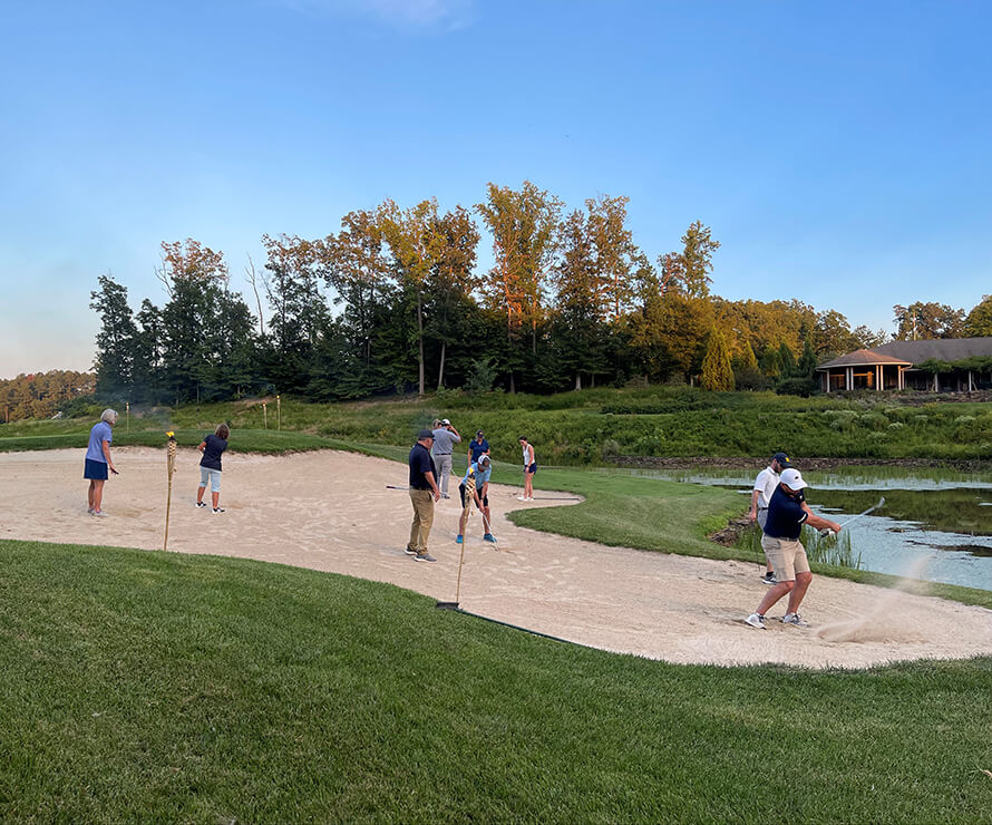 golfers in a sand trap